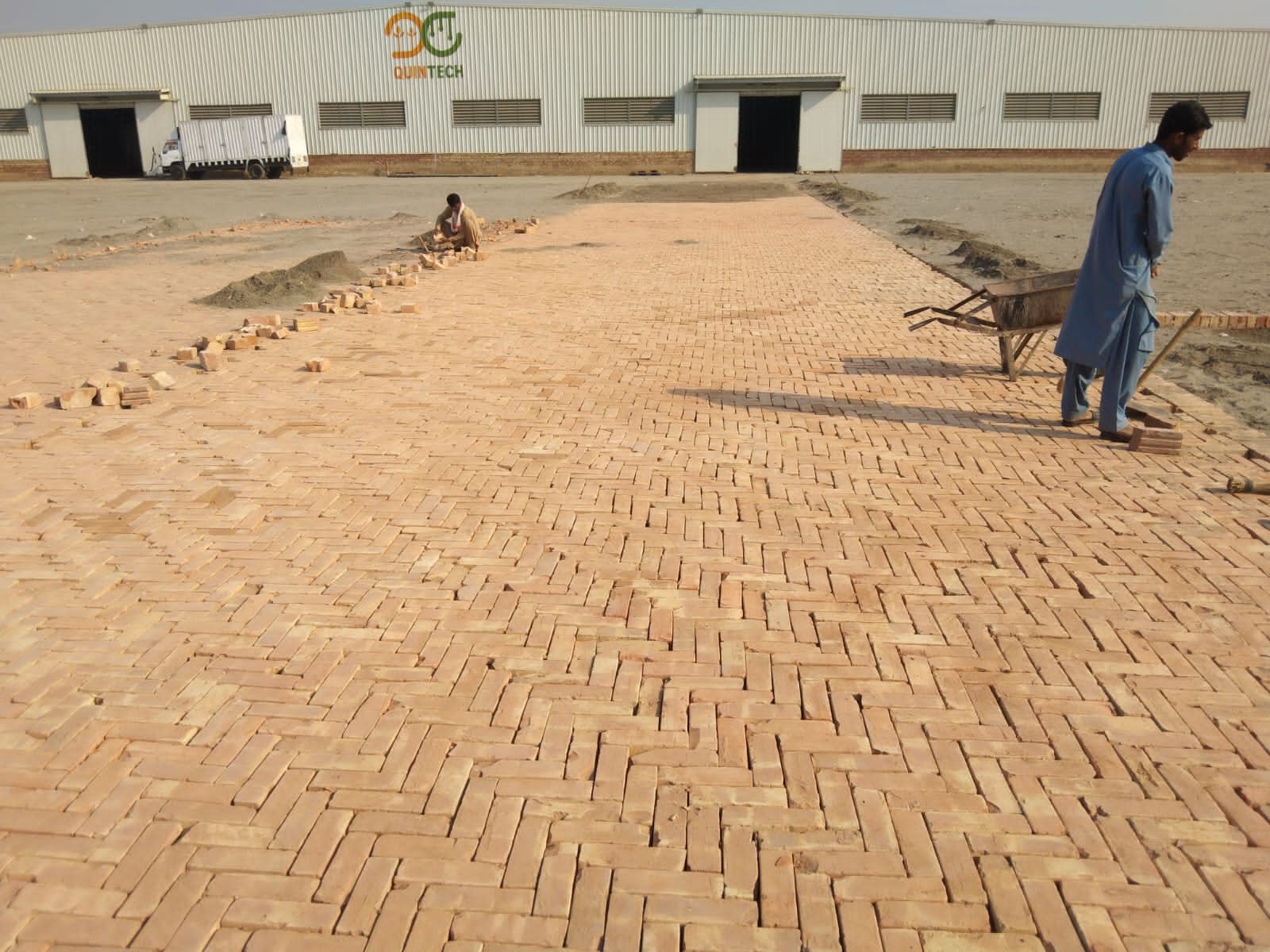 Herringbone brick paving in progress